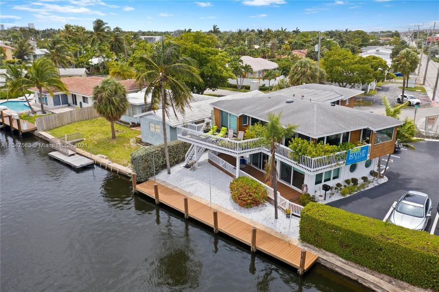 Presenting a fully renovated, turn-key mixed-use waterfront property on a high-visibility corner just steps from Federal Highway. This two-story asset features an oversized wraparound balcony overlooking the waterway, tranquil southeast views, and a private dock with a 90' seawall rebuilt in 2017.Nearly rebuilt in 2012 with new electric, plumbing, flooring, and structural upgrades, the property also features hurricane impact windows and doors throughout, multiple entrances, LED lighting, and six HVAC zones.The first floor is commercial, currently configured as three bays, including a beautifully remodeled waterfront suite with modern glass partitions, a waterfront conference room, private offices, and upgraded finishes throughout. The bays can easily be combined into a larger