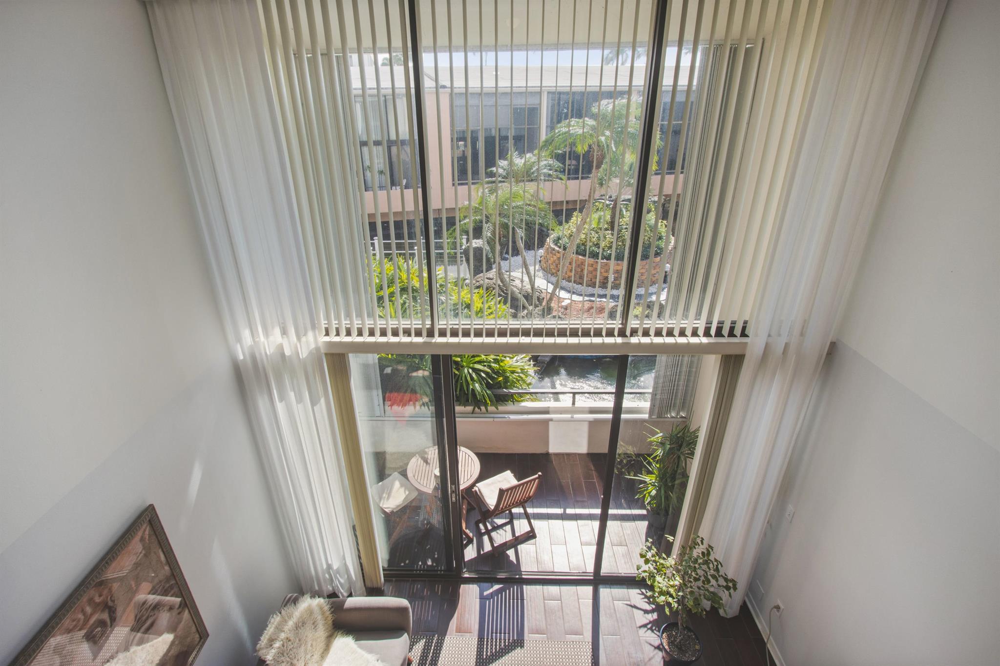 BEACH VILLA- A rare opportunity to own this  amazing loft townhouse, directly across from the beach.  Remodeled unit with open floor plan, loft style bedroom, 2 full bathrooms, and 2 STORY impact windows overlooking resort style lagoon and pool.  Assigned parking space directly in front of unit.  Full Amenity building includes doorman, deeded beach access, 2 pools, fitness, etc.  Best location near Eau Resort, Restaurants, Shopping, etc.  Amazing price for this beach house in south Palm Beach.
