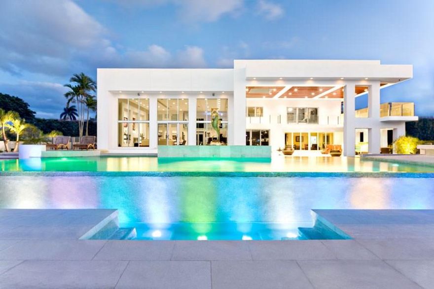Extraordinary Modern architecture - 120 ft waterfront & wide open North Lake views (flows to intracoastal).2009 extensive renovation no expense/detail spared. Popular magazine/movie filming location. Immediately impressive,walled & gated entry, expansive motor court. Soaring ceilings & open entertaining areas perfectly showcase incredible views. Entertainer's delight in both Chef's & outdoor Summer Kitchen + custom wine cellar. Maid/M-I-L suite.Impact glass.Resort style pool. Potential seller financing!