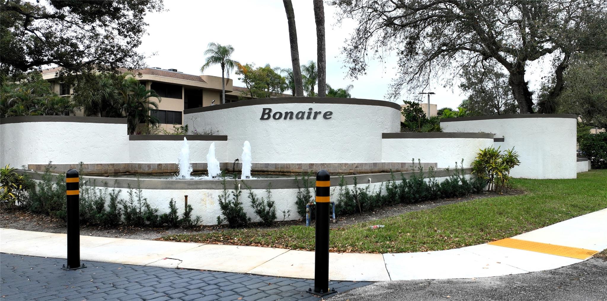 Beautifully remodeled 2 bedroom, 2 bathroom condo in Bonaire at Woodmont. Step into this stunning, modern home featuring light gray tile throughout and an open concept kitchen with granite countertops, stainless steel appliances, and ample storage space. Upon entry, you will find a versatile bonus space perfect for a small office or cozy breakfast nook. The spacious dining/living area is ideal for entertaining, while the large master bedroom boasts a walk-in closet plus two additional closets. The en-suite bathroom offers dual sinks, a frameless glass shower door and a sleek modern shower fixture. The second bedroom is generously sized, complete with plantation shutters. Additional highlights include accordion shutters, remote control blinds, no popcorn ceiling and upgraded PEX piping.
