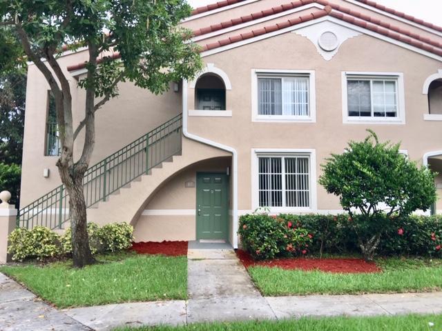 First floor corner unit with assigned parking. Exceptionally clean and bright. Large master suite with two closets. 18'' tile, new lighting fixtures, new fans and new high efficiency air conditioning. Walk-in pantry, spacious kitchen with raised breakfast bar, refrigerator, glass top oven, dishwasher, washer and dryer. Private open covered patio and security system. Luxury gated community with a resort style lakefront pool, spa, fitness center and clubhouse. Short walking distance to Boynton Beach Park. Water and cable included.