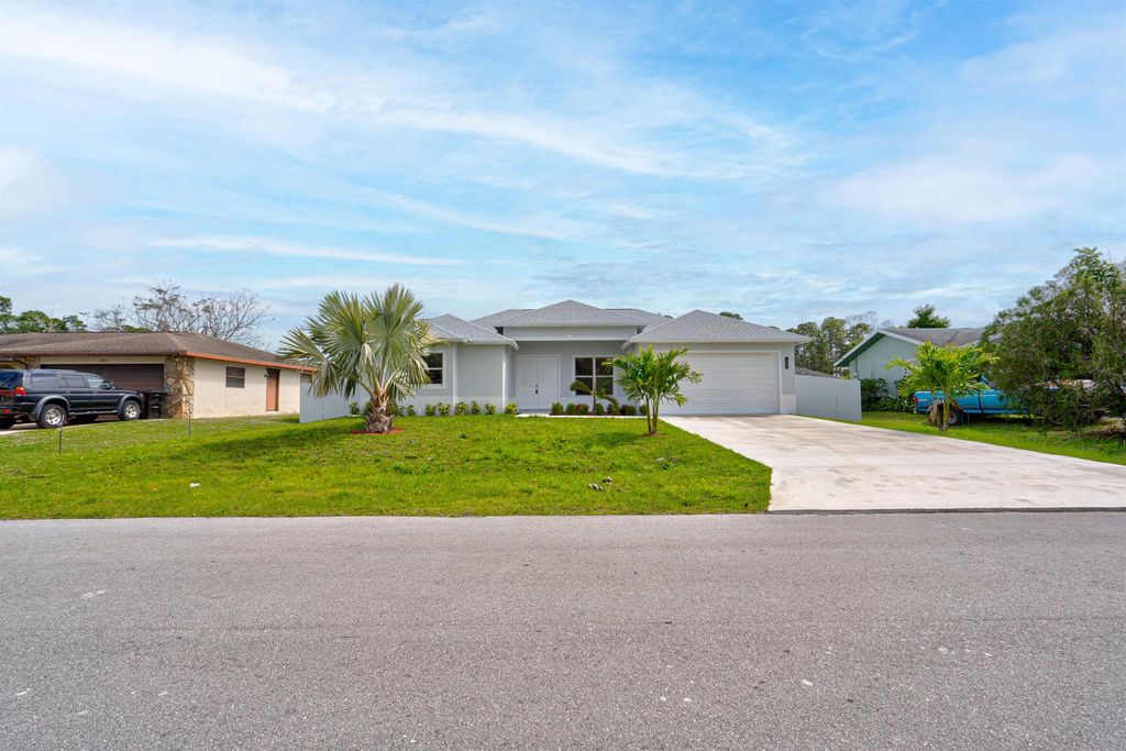 Photo of 1825 SW Logan Street, Port Saint Lucie, FL 34953 (MLS # R10943294)