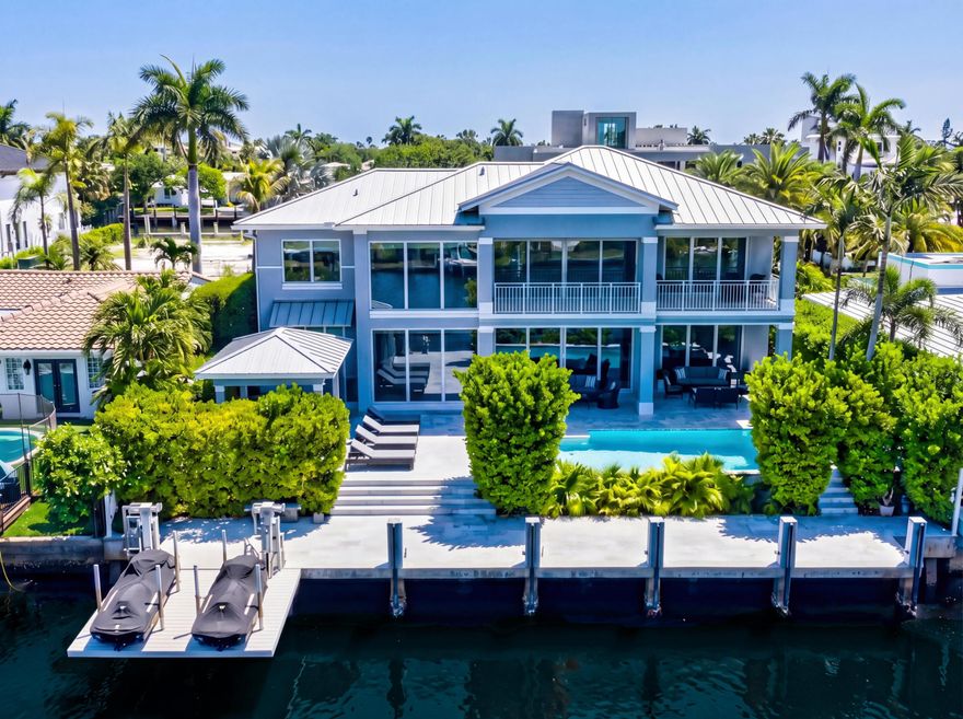 Stunning Coastal Contemporary Deepwater Estate recently built in 2018 is sited on 75' of water-frontage in the Riviera Isles enclave of Las Olas Isles. Conceived by Tuthill Architecture and built by U-BACK Construction, this 5 Bed, 5 full and one-half Bath residence boasts 4,901 +/- total sq ft across 2 floors of luxurious living. Pristine Thassos Snow White marble floors laid throughout. Soaring double-height ceilings and walls of glass provide an abundance of nature light and water views from every major room. Large chef's kitchen complete with Subzero & Bertazonni appliances with pocketing sliding doors that open completely, connecting the waterside summer kitchen allowing for effortless poolside entertaining & al fresco service. Leathered marble deck & dock with whole home generator.