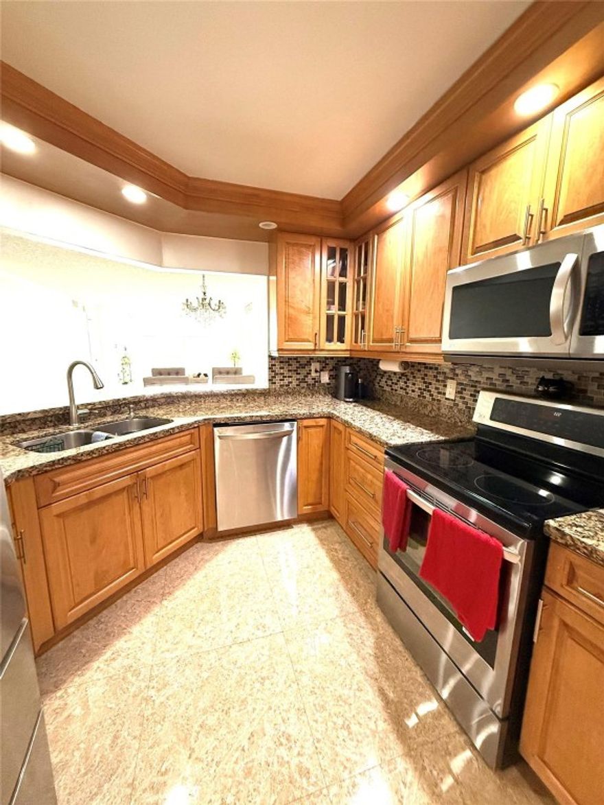 Spacious 2 bedrooms / 2 bathrooms apartment located in Sunrise, just minutes from Sawgrass Mills Mall. Situated in Sunrise Lakes Phase 4, a well-maintained 55+ community. This bright unit offers approximately 1,400 sq ft of living space and includes private storage. The apartment features porcelain floors throughout, real wood flooring in the primary bedroom, an extended Florida Room, and a fully remodeled kitchen with wood cabinets, granite countertops, and stainless-steel appliances. Bathrooms include a Roman tub, and the unit also offers a separate laundry room with washer and dryer inside for added convenience.