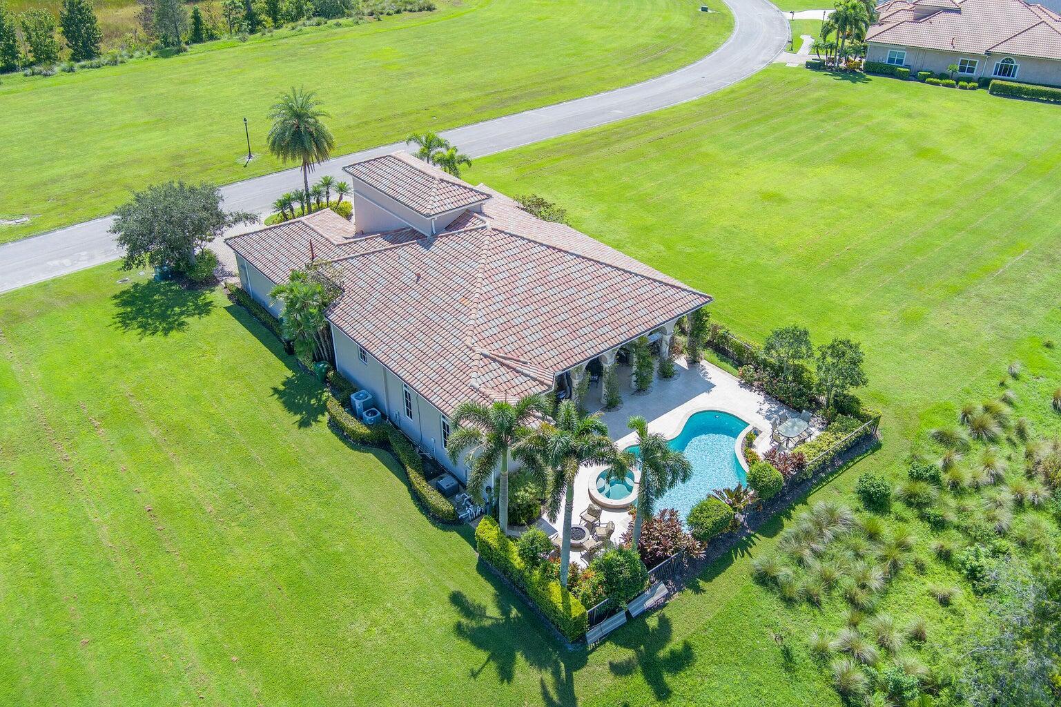 Experience privacy in this newly painted fully furnished Tuscan-style home. The 37ft. long covered porch overlooks a newly resurfaced lap pool with a hot tub & features an outdoor kitchen with a natural gas grill; the fire pit has views of a preserve, 16th fairway & pond. 5 double French doors lead from the porch into the Great room & kitchen. The refinished marble floors accent all the indoor entertainment areas. The private office/den has wood floors. Each Bedroom with ensuite baths, designed for maximum privacy, has been updated with new carpets. The Main Bedroom suite has a 14 ft high tray ceiling, both his & her private baths, and 2 walk-in closets featuring custom cabinets. Updated AC's, New pool heater, New Tankless water heater, EV Car & Golf Cart charger, 400 amp service.