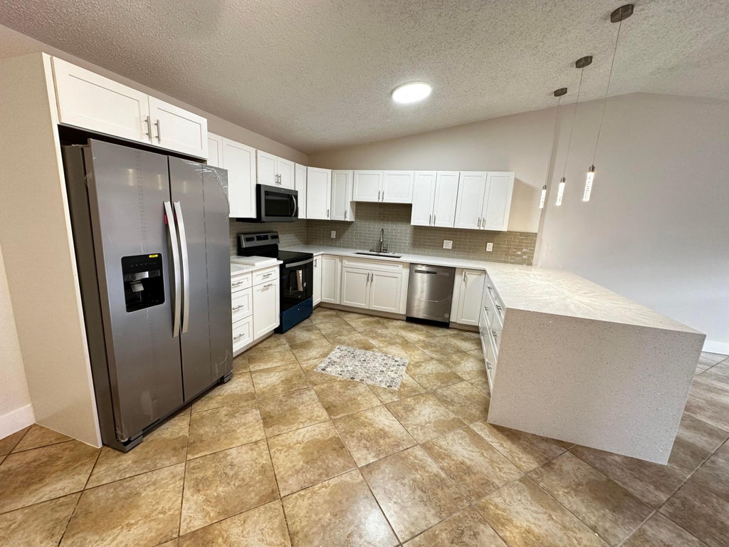 Photo of 4326 Woodstock Drive #C, West Palm Beach, FL 33409 (MLS # B26058303)