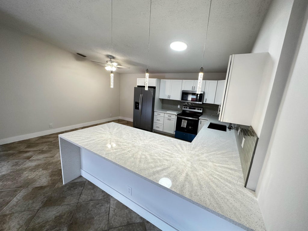 Photo of 4326 Woodstock Drive #C, West Palm Beach, FL 33409 (MLS # B26058303)