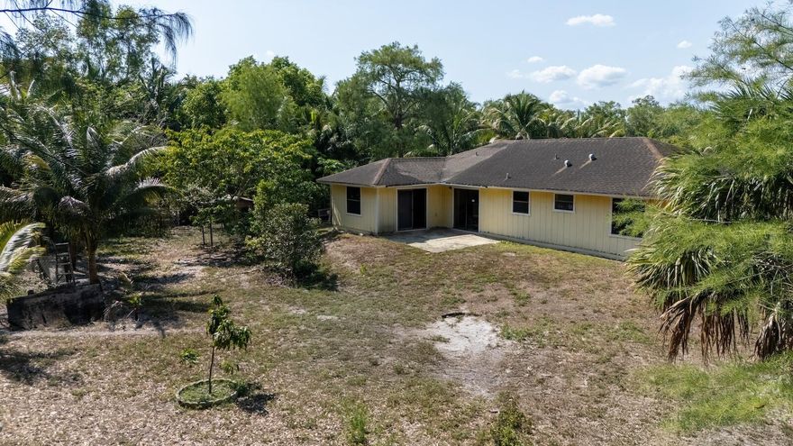 Spacious 3BR/2BA single-family home on a 1.47-acre lot in desirable Loxahatchee. The property needs some TLC but has incredible potential—perfect for investors, homeowners, or equestrian enthusiasts. Located in a horse-friendly community with no HOA. Property features a variety of mature fruit trees including mango, jackfruit, coconut, and more—an ideal setup for anyone who enjoys fresh, tropical fruit right in their backyard. Three adjacent lots are also available for sale. The city is actively upgrading the street with new asphalt paving in progress. Enjoy peaceful, rural living just minutes from new shopping centers, restaurants, and grocery stores. Cash or conventional financing preferred due to condition.