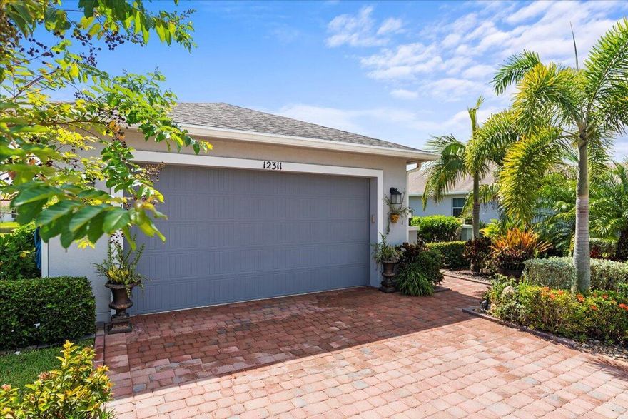 Resort Style Waterfront Home offers 2 bedrooms, 2 bath, plus Den, in the highly desirable 55+ Active community of Vitalia in Tradition, Florida. This 2017 built open concept home is perfect for entertaining all your friends & family. The beautiful kitchen features a large island, 42'' cabinets and granite counters, SS appliances & pantry. The owner's suite features a large walk-in closet, double vanities and large walk-in shower. Step out to your waterfront screened-in lanai or enjoy the large front Courtyard for entertaining. Additional features include Plantation Shutters, laundry room with cabinets, whole house impact glass and enjoy the security of a whole House Generator. 
Note: Hurricane Shutters around the whole Lanai Vitalia is an extremely active 55+ community with over 50+ clubs to join, 24,000 sf Clubhouse, Ballroom/Theater, 2 swimming pools, card rooms, billiards, darts, basketball, tennis courts, pickleball courts, bocce ball, shuffleboard, horseshoes, Workout Area with Trainers with an onsite activities' director and much more. Minutes from I-95, Cleveland Clinic Hospitals, shopping, restaurants, fishing, golfing and close to our beautiful beaches.