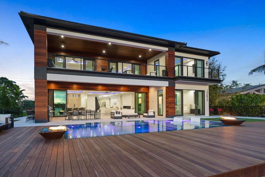 Unmatched waterfront views from this brand new construction home in Tequesta Country Club! Just minutes to the Jupiter Inlet for quick ocean access or a leisurely ride to some of the best waterfront dining the area has to offer. Take in the beauty of the tranquil waters of the Loxahatchee River from nearly every reimagined space. Enjoy the serene Euro-edge pool and spa with spacious sun deck, an expansive dock, open ipe deck with copper-clad fire bowls and a covered patio with bar seating along the summer kitchen. Generous 10' sliding doors fully retract to reveal an elegant open-concept living space with large format porcelain floor tile and lighted tray ceilings. Versatile floor plan offers 7 bedrooms plus club room, 7 full, 2 half baths and 4 car plus golf cart garage parking.