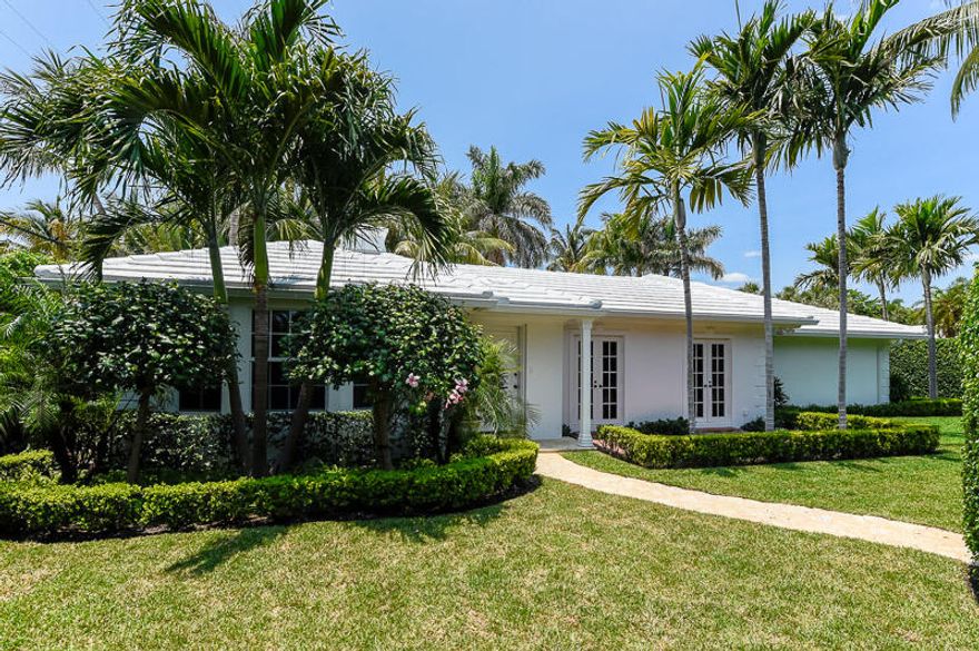 Located on the coveted North End of Palm Beach, this 3 bedroom, 3 bath, Bermuda style home is pristine and move-in ready.  It is a one-story home that is light and bright and sited on a large lot.  Beautifully renovated, the home boasts a large high end eat-in-kitchen with stainless steel appliances and granite counters.  The spacious living room with its high tray ceiling and adjoining dining room surround the beautiful pool area, and French doors provide access to the backyard for easy entertaining.   The master bedroom suite with its bay window is serene and separate from the guest wing.  The large master bathroom boasts a  marble floor, subway tile and a soothing rain shower.   Two ensuite guest bedrooms with French doors lead to their own private brick patios.