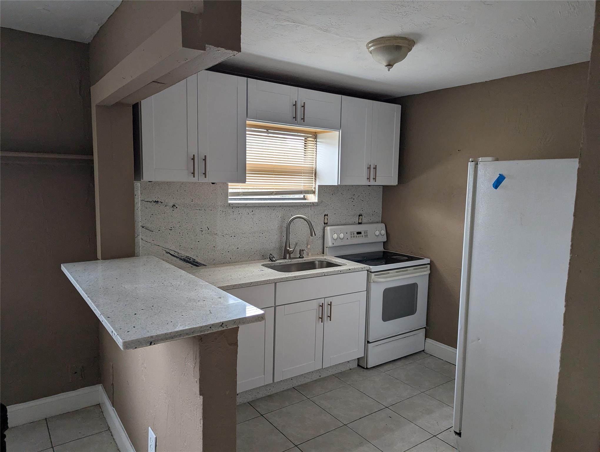 New white cabinets in the kitchen, new granite kitchen, granite backsplash, granite bar counter open porch, near a bus stop, near turnpike, library, and Park. All tile, stove top, and tile floors. Only seconds to the bus stop. Newly updated bathroom. Quick and easy approval. ,