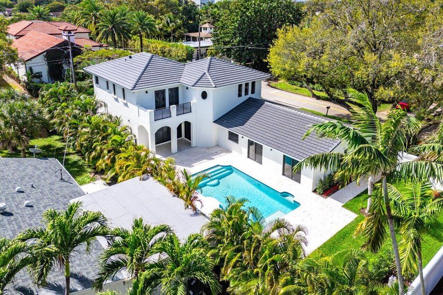 Welcome to this stunning TURN KEY East Boca home located in the sought after neighborhood of Palm Beach Farms. Featuring 6 rooms (4 bedrooms, an office, and a flex space) and a total of 4,541 total sq ft! This home has been renovated to meet modern standards with 3 beautifully renovated bathrooms, new plumbing, updated electrical wiring, impact doors and windows, a new A/C system, and a NEW roof. The chef-inspired kitchen is a showstopper with gorgeous Taj Mahal quartzite countertops and top-of-the-line new appliances, making it a perfect space for cooking and entertaining. Set on a large private corner lot offering a balance of indoor and outdoor living! Step outside to enjoy the tranquility and privacy of your own oasis featuring a newly resurfaced pool and pool deck along with a newly