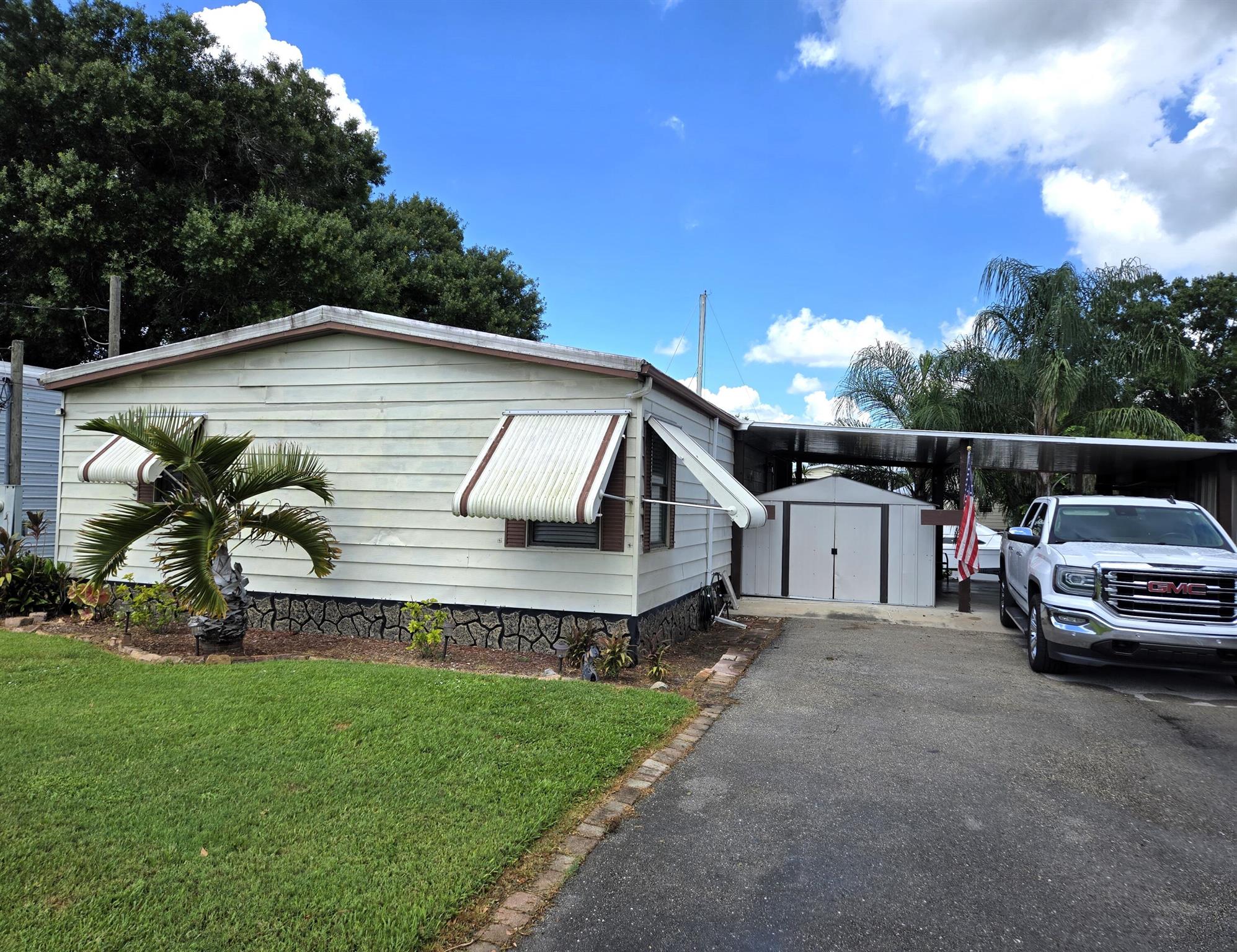 TREASURE ISLAND - DWMH - This 2 bdrm 2 ba home has 1,004 sf under air with 2,276 total living sf. Home has many upgrades less than 5 years old to include kitchen, appliances, cabinets, baths, flooring, paint & light fixtures. AC replaced 5 yrs to include new duct work. New HWH. Enclosed Florida room provides additional living space with windows overlooking canal. Covered porch is perfect location for morning coffee and sunset breezes. New paver sidewalk leads to boat house with power & lift. Seawall. Carport. A 10' x 22' workshop and a 8' x 10' shed provides plenty of storage for all your outdoor tools and toys. Wide canal leads to Taylor Creek. Furniture is less than 2 yrs old and negotiable. This home will not disappoint - don't miss out! Room dimensions are approximate.