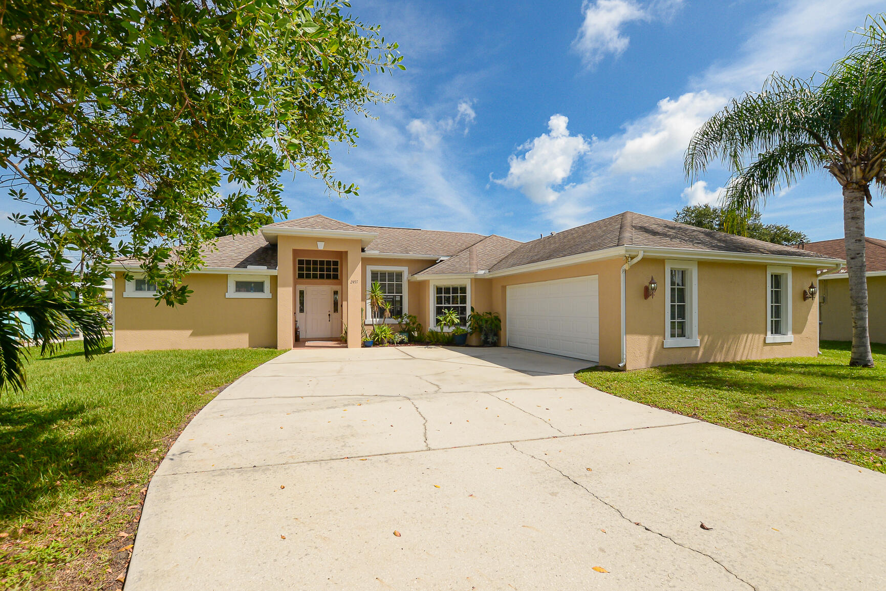 3/2/2 GREAT LOCATION, GREAT COMMUNITY! Fully Fenced Large yard with room for a pool! (Ready to add an above ground pool -concrete in back yard) Extra Large screened and covered patio. AC installed Dec. 2021, newer Stainless Dishwasher, & Refrigerator. Large beautiful Neutral Tile throughout living area. Wood laminate & vinyl floors in bedrooms. Natural lighting from plenty of windows. Ext and Int. House painted 2 years ago with top Sherwin Williams paint.Large main bedroom suite. Dual sinks, Large separate tub, separate shower, Hideaway Toilet area. Large Dual walk-in closets in main bedroom. Only 5 miles to beautiful Jensen Beach Downtown and 7.4 miles to Hutchinson Island Jensen Beach! Close to Jensen Shopping, restaurants & more. See all pictures. NO HOA! Don't wait!!