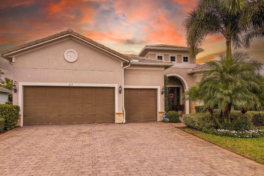 Attention to detail shines throughout this beautifully upgraded 2017 home in the highly sought-after, 31-home community of Shores Pointe located in the heart of Jupiter. This sought-after Pinnacle one-story, split-bedroom floor plan offers 3 bedrooms, 3 baths PLUS a den/flex room & a spacious 3 car garage. From the moment you enter the custom impact glass double doors, you'll notice the thoughtful designer upgrades, including porcelain wood-look tile flooring, coastal inspired light fixtures, crown molding, plantation shutters, tray ceilings, and refined finishes throughout. Built for comfort and peace of mind, the home features CBS construction, impact glass windows & doors, natural gas, and a whole-house generator. The open-concept great room is both inviting and functional, highlighted by a stunning chandelier and zero-corner sliding glass doors that pocket seamlessly into the exterior walls, creating an effortless indoor-outdoor connection. The gourmet kitchen is a true showpiece, boasting a huge quartz center island with beautiful pendant lighting, white shaker cabinetry, marble backsplash, a 5-burner gas range, a large walk-in pantry, and a coffee/wine bar area - perfect for both everyday living and entertaining. Rest peacefully in the expansive primary suite featuring a volume tray ceiling with crown molding and a sleek ceiling fan. A massive walk-in closet with custom built-ins provides exceptional storage. Luxuriate in the spa-inspired primary bath with porcelain tile flooring, quartz countertops, elegant vanity lighting, a large soaking tub, and a frameless glass walk-in shower. The den/flex room has been upgraded with custom glass French doors and can double as a convertible 4th bedroom, media room or home gym. Both guest bedrooms are generously sized, with one bedroom offering an en-suite bath and walk-in closet. Step outside through the zero-corner sliders to a private, resort-style backyard designed for both relaxation and entertaining. Enjoy stunning sunset views from the screen-enclosed extended covered lanai with a motorized retractable screen. The custom built freeform saltwater heated pool and spa is the perfect spot to end your day with a raised spa & waterfall and sunshelf. The travertine pavers extend from the patio throughout the entire pool area. There's even a natural gas stacked stone fire pit + seating area for intimate gatherings. Mature palm trees, lush tropical privacy hedges, custom landscape lighting, and gas-fed tiki torches encompass the backyard to create an incredibly private and serene outdoor setting. Additional highlights include smart home features such as a Ring doorbell camera, ADT exterior security cameras, and a smart thermostat. Shores Pointe is zoned for A-rated schools and is conveniently located within close proximity of I-95 and the FL Turnpike, beaches, shopping, restaurants, parks & nature preserves. The community also offers a private playground/park and walking path access to the SW Fork Loxahatchee River where you can launch a paddleboard or kayak. Conveniently located near I-95, the Florida Turnpike, beaches, shopping, dining, parks, and nature preserves. This is Florida living at its finest!