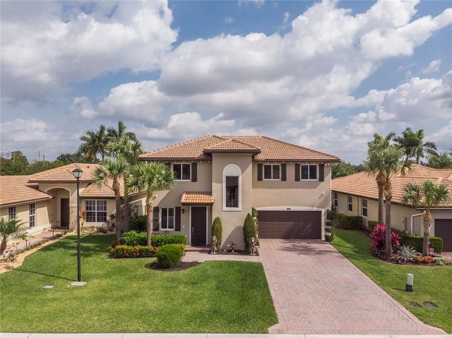 BEAUTIFUL pool home in gated Vista Lago!  Not many come up in this pretty development! Built in 2016, seated near the end of a private street is this 4 bed, 2.5 bath two story home thats ready to go! Gorgeous contemporary saltwater heated pool with waterfall, deck jets, spa, and ample travertine pool deck. Located on HUGE fenced lot with room for parties, weddings, a garden, or even trampolines!! Parking for 4 in driveway and 2 in garage. All impact windows and doors, exterior cameras, outdoor seating with video/tv. Inside has 42" cabinets in kitchen, both living room and sitting room/parlor, all bedrooms upstairs with large primary walk-in closets. Schools are Christa McAuliffe Middle and Park Vista High! So happy to present this home to you! Assoc only 291!  covers LAWN, gate, cmmty pool, playground!
