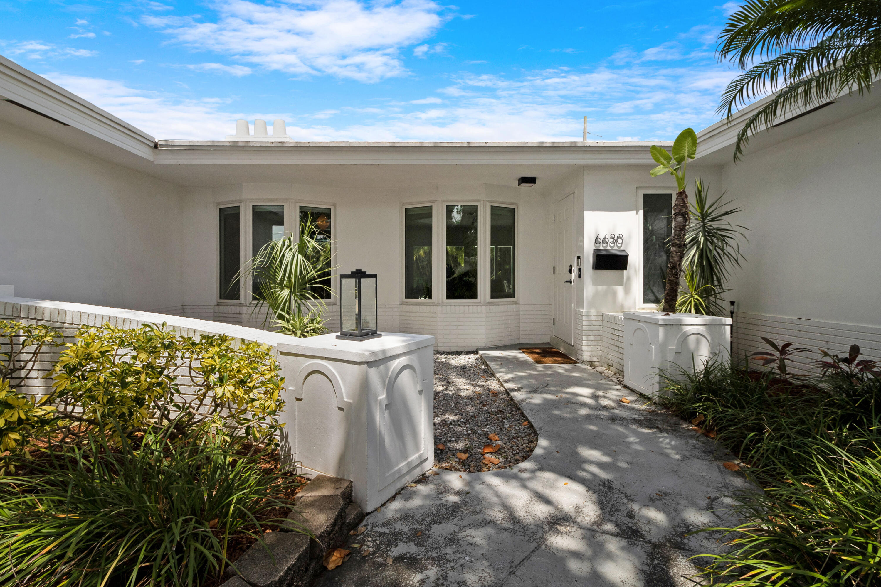 Welcome to this beautifully renovated 3/2, pool home in the highly sought-after Imperial Point neighborhood. Nestled on a lushly landscaped corner lot, this property boasts incredible curb appeal with a decorative circular driveway, courtyard entry, & full 2 car garage with epoxy flooring and air conditioning. Featuring Evie Haya premium porcelain tile flooring throughout and freshly painted interiors, this home blends modern comfort with designer finishes. The stunning primary bathroom showcases luxury porcelain tile, a frameless glass shower, a modern vanity, Delta TempAssure shower system, and bronze fixtures from Ferguson. Upgrades include complete impact glass and doors, a new RHEEM 80-gallon electric water heater, trenchless pipelined sewer system, smart thermostat,