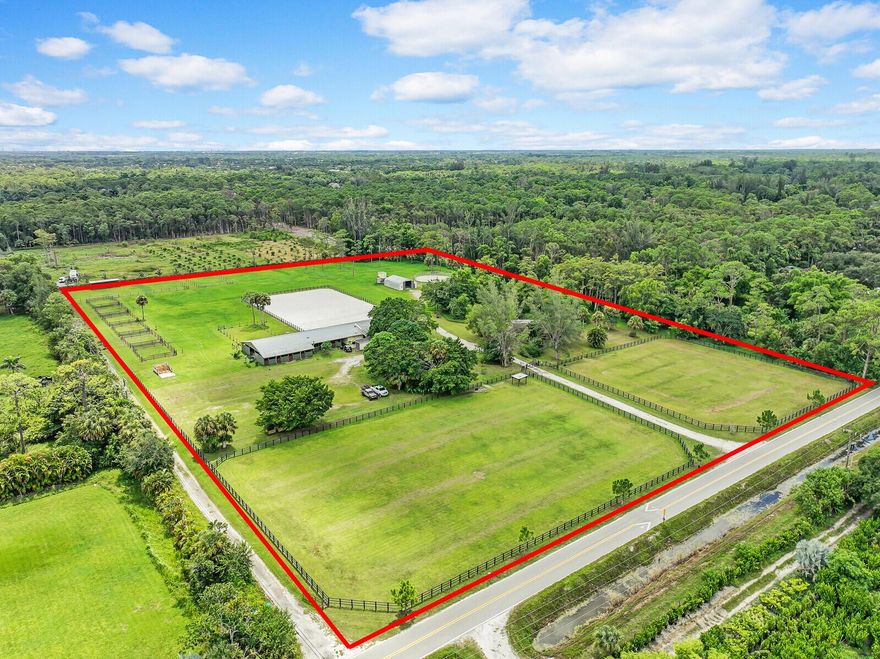 This impressive equestrian estate spans 11 acres on a paved road, just minutes from Wellington. The property offers a versatile space with a recently updated residence featuring 2 bedrooms, 2 bathrooms, a large enclosed patio flex room, and an attached one-bedroom apartment. The spacious center aisle barn includes 21 stalls (with potential for 24), Saratoga stalls, stable comfort mattress systems, bathrooms, tack rooms, wash and grooming stalls, and water access to every stall. The property also includes a round pen, a 120x200 ft arena with EquiSafe fencing, and large front paddocks. The land has been meticulously designed with proper drainage and irrigation systems for the paddocks and arena, each on separate wells and pumps. The house and barn have their own water systems as well!