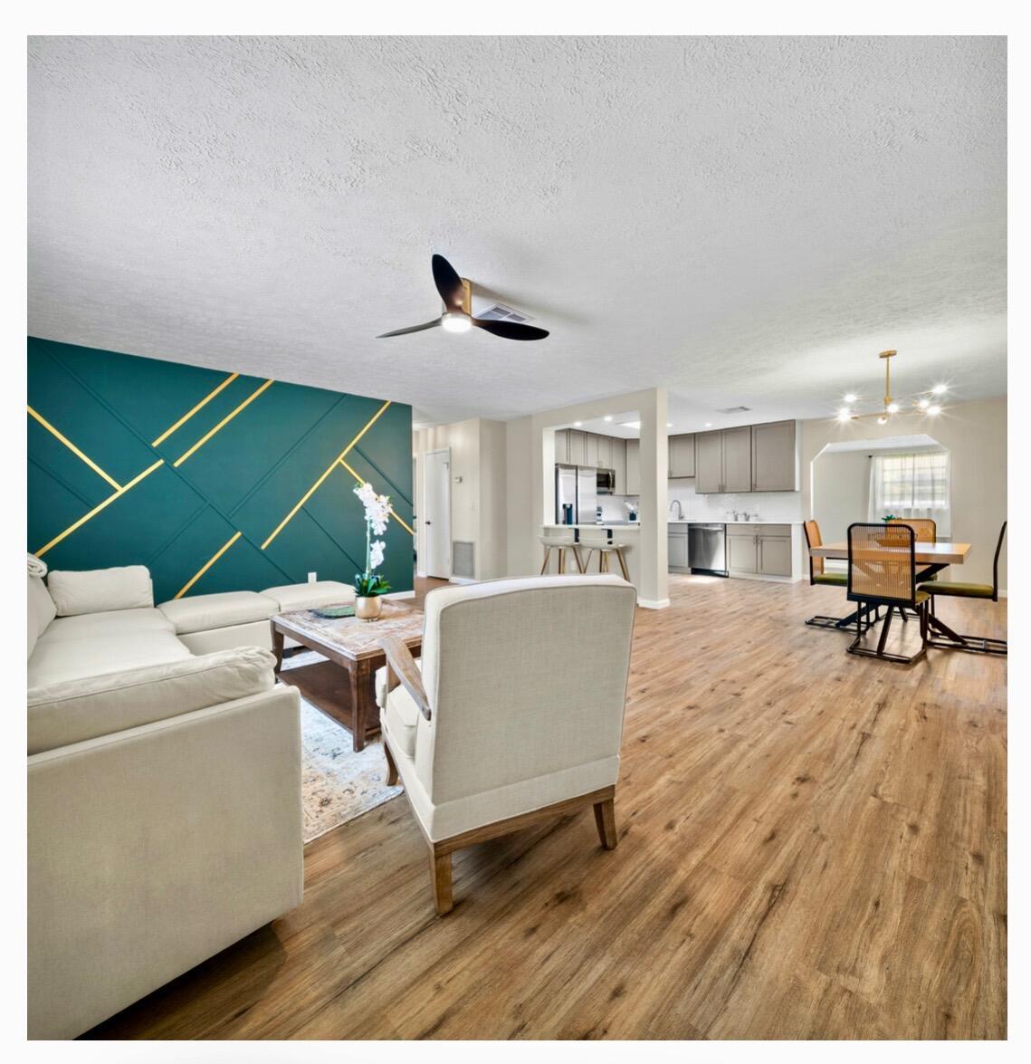 Welcome to your move-in ready oasis. This tastefully renovated 2 bedroom, 2 bathroom home has it all, including a 1-car garage and expanded driveway with room for your boat, RV or both. Recent updates and features: Freshly painted inside and out for a crisp, modern look. Roof (2022) and newer HVAC system (2019) for peace of mind. Bright and airy living area with NEW luxury vinyl flooring throughout . Stylish kitchen featuring NEW stainless-steel appliances, 42' cabinets for extra storage, brand-NEW quartz countertops, and a sun filled skylight. Spacious bedrooms one with walk-in closet. Remodeled bathrooms with generous storage solutions. Large enclosed porch-ideal for morning coffee or entertaining. Expansive yard with plenty of room to add your dream pool. Relax, unwind, you're home!