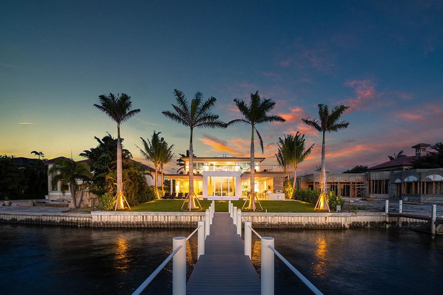 This Modern Island Transitional home exudes a feeling of tranquility and sophistication. Located on exclusive Hypoluxo Island, this waterfront paradise provides stunning views of the Intracoastal. This stunningly designed and newly built home boasts five bedrooms and five and two half bathrooms. A magnificent two-story foyer greets you upon entry and leads you into the brilliantly illuminated club room with a curved Cypress ceiling. Natural light pours in through the 12' floor to ceiling windows creating a bright and airy atmosphere. This room is a remarkable feature in itself, cantilevered over the mesmerizing pool.