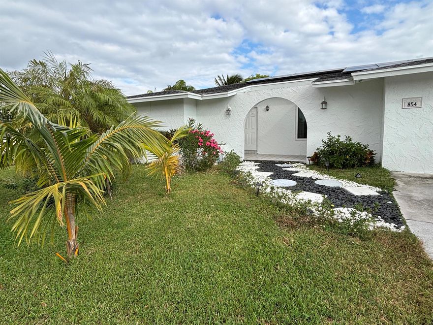 This is a beautifully renovated 3-bedroom, 2-bath, 2-car garage home in the heart of Royal Palm Beach! Step into an open and spacious floor plan with elegant porcelain tile throughout, brand-new impact windows and doors, and a huge updated kitchen featuring an eat-in dining area perfect for family gatherings. Enjoy a private, fully fenced backyard with a large covered patio--ideal for relaxing or entertaining guests. Located just minutes from top-rated shopping, dining, and parks, this home offers convenience and comfort in one of the most desirable communities. Special Offer: If the buyer uses our preferred lender, they will receive a $4,000 credit toward closing costs! Don't miss out on this incredible value! ask the listing agent for more information on our preferred lender