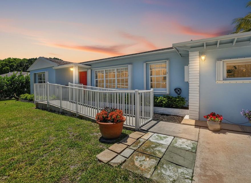 This well kept 4 bedroom, 3 bathroom single family residence in Boca Raton delivers comfort, practicality, and flexibility with no HOA limitations. Showcasing timeless Florida ranch design, the home features a bold coastal blue exterior paired with a vivid red front entrance, enhanced by lush tropical landscaping and an handicap accessible ramp. Inside, the home offers a light-filled open layout with upgraded wood-plank flooring and a soft neutral color scheme flowing through the living, dining, and kitchen spaces. Expansive windows allow natural light to pour in throughout the day, while the main family room opens through sliding glass doors to the backyard, blending indoor and outdoor living with ease. The updated kitchen is equipped with white Shaker cabinetry, quartz-style countertops, a marble-inspired backsplash, and stainless steel appliances. Its open design connects directly to the main living areas, making it ideal for both daily use and hosting.  All 3 bedrooms provide a comfortable and versatile space, featuring wood-look flooring, ample closet storage, and a clean, modern design that works well for a primary suite, guest rooms, home office, gym, or any flexible lifestyle need.  The primary bathroom features a white vanity with an integrated sink, mirrored medicine cabinet, walk-in glass-enclosed shower, built-in shelving, grab bars, and wood-look flooring. Both bathrooms are thoughtfully designed with practical layouts and neutral finishes, including updated vanities, tiled surrounds, and durable fixtures ideal for everyday use. The secondary bathroom includes a natural wood vanity, tub and shower combination, white tile surround, chrome accents, and consistent flooring throughout the home.  Out back, enjoy a generously sized, fully fenced in yard on an oversized lot with plenty of room to design your ideal outdoor space whether that includes a pool, outdoor kitchen, play area, putting green, or future additions.  Additional features include an interior laundry room, a fully fenced backyard, and a separate storage structure at the rear of the property.  Located in the sought-after Beulah Heights area, the home is just minutes from top-rated Boca Raton schools, including Boca Raton Elementary, Boca Raton Community Middle, and Boca Raton Community High. You're also close to premier destinations such as Town Center at Boca Raton and Mizner Park, along with popular dining, entertainment, and nightlife options like Louie Bossi's, Kapow Noodle Bar, Farmer's Table, Mizner Park Amphitheater, and the Funky Biscuit—offering a true Boca lifestyle of convenience and entertainment.