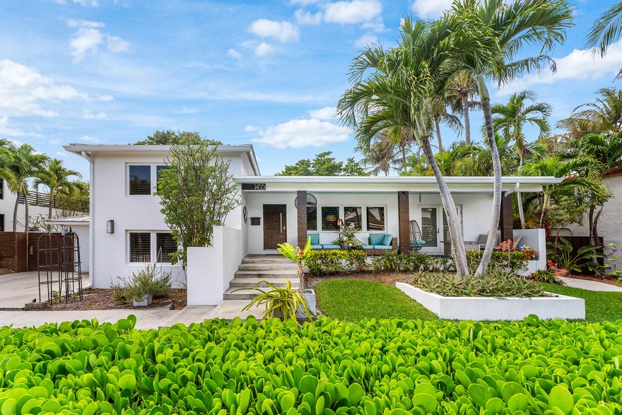 This exceptional East Boca residence is located in the highly desirable Golden Triangle, just minutes from Mizner Park and the beach. This meticulously redesigned home in 2017 features complete hurricane-impact windows and doors, a durable metal roof (2018), and all-new plumbing and electrical systems for peace of mind.  The thoughtfully designed split-level floor plan is enhanced by plantation shutters and abundant natural light throughout. The gourmet kitchen showcases quartz countertops, a striking walnut island, glass tile backsplash, and high-end stainless steel appliances.  The lower level offers a versatile living area complete with a kitchenette and full bath -- for guests, in-laws, or flexible living arrangements.  Step outside to a screened back porch with electric screens, creating seamless indoor-outdoor living. The fully fenced yard offers ample space for a future pool, while the detached shed with A/C and electricity provides the perfect opportunity for a home office, yoga studio, or creative retreat.  Additional highlights include two 220V outlets for electric vehicle or RV charging, a tankless water heater, an electrically programmed sprinkler system, and an oversized driveway with space to accommodate up to seven vehicles or an RV.