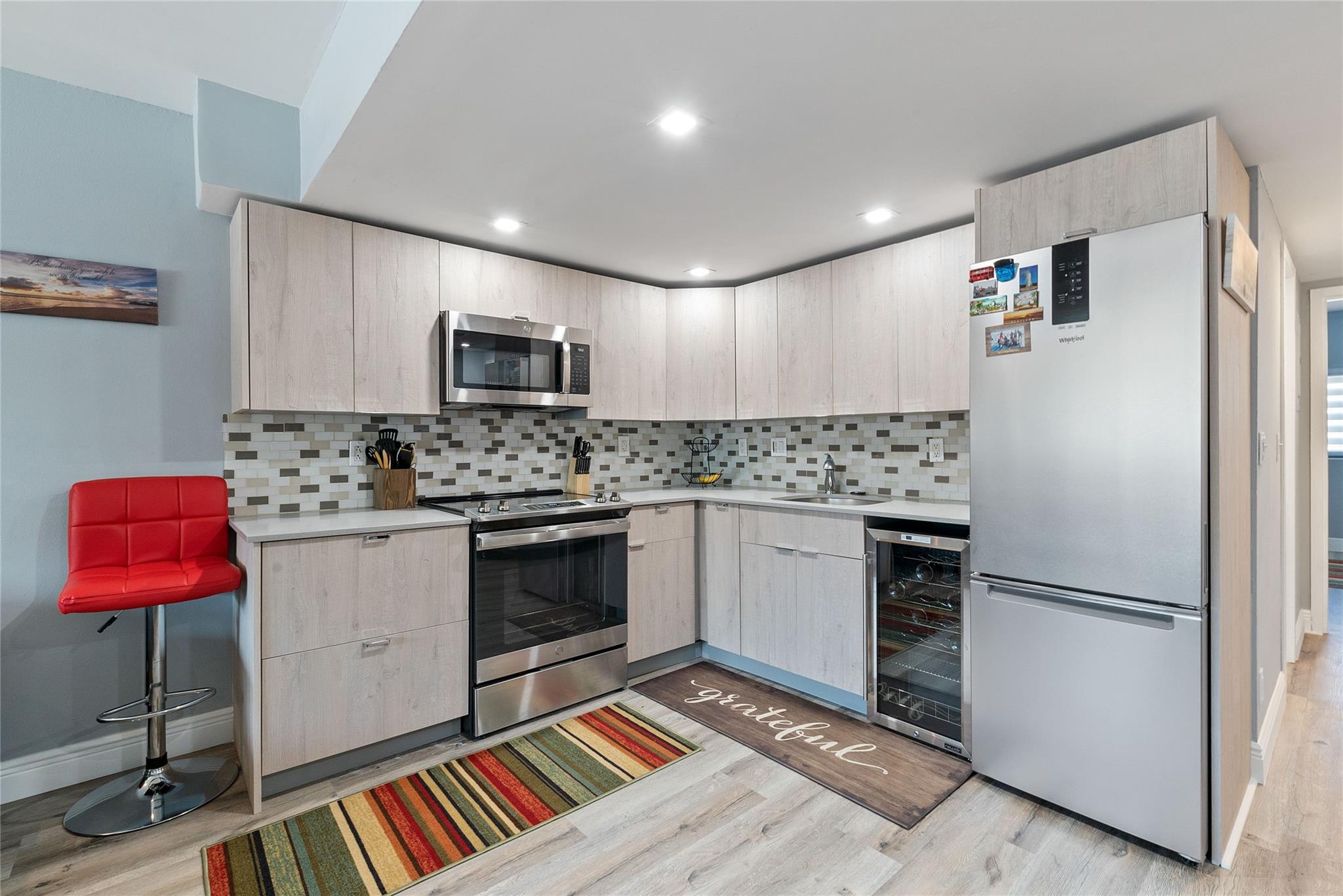 Step into the epitome of modern living with this meticulously remodeled condo, nestled in the vibrant heart of Wilton Manors. This ground-floor gem has been completely transformed, boasting an open-concept design that seamlessly blends the living, dining, and kitchen areas into a harmonious space. The kitchen features sleek quartz countertops, custom wood cabinetry, and top-of-the-line stainless steel appliances. Every inch of this condo has been updated, including a stylish bathroom, spacious closets, and durable vinyl flooring that combines the look of wood with the ease of maintenance. Beyond the stunning interior, this condo has hurricane-impact windows and doors for your peace of mind, along with a brand-new electrical panel ensuring modern efficiency and safety.