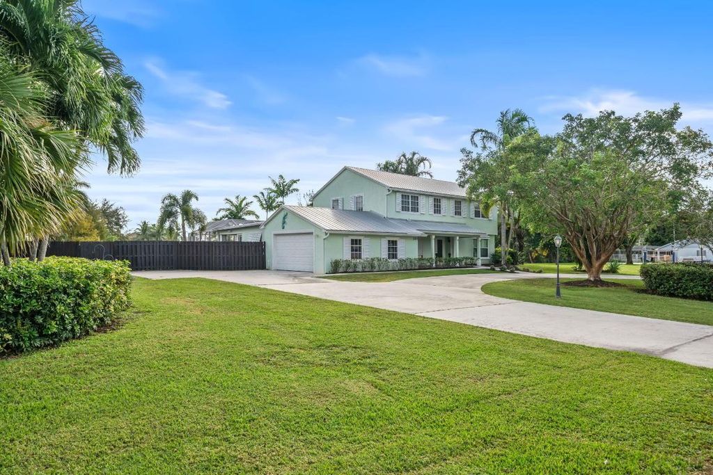 Photo of 864 Whippoorwill Row, West Palm Beach, FL 33411 (MLS # R11112390)