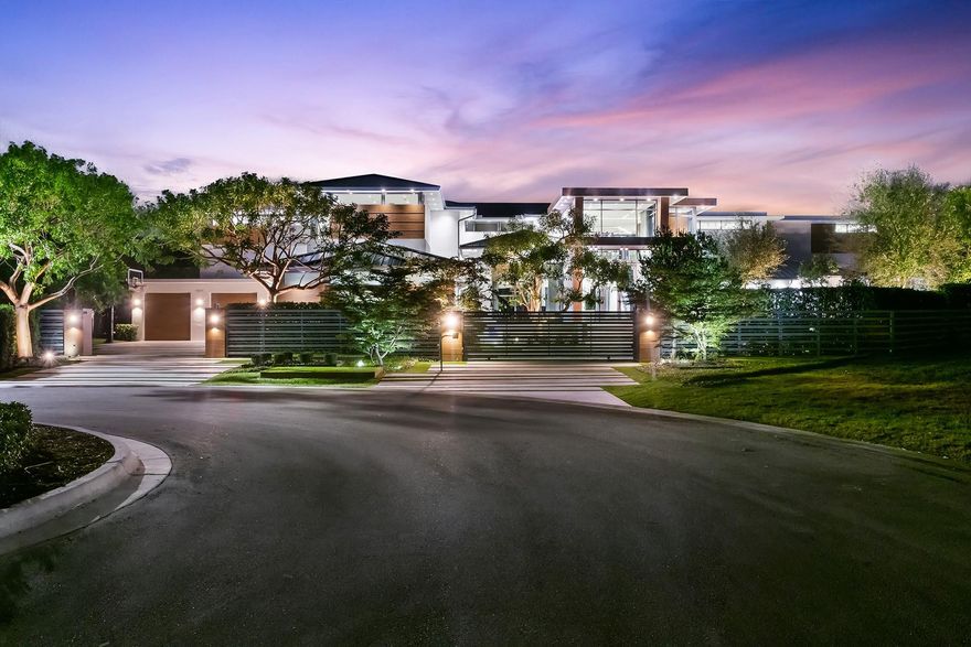 The most architecturally designed lakefront estate in the premier guard-gated community of Hawks Landing. Set on nearly an acre, this 17,400 sq ft modern residence captures light, water views, and glowing sunsets. The soaring 35-foot ceilings, dual floating steel staircases, and glass wine room define the interior. The Bulthaup kitchen opens through Nano doors to a resort-style 80' pool, waterfall, and expansive outdoor entertaining area with a full kitchen. The loft-inspired primary suite offers sliding oak doors and panoramic views. Some of the additional features include en-suite bedrooms, a state-of-the-art gym, an 8-seat movie theatre, and a private guest house. Hawks Landing offers a clubhouse with a fitness center, tennis, pickleball, playground & 24-hour guard-gated security.