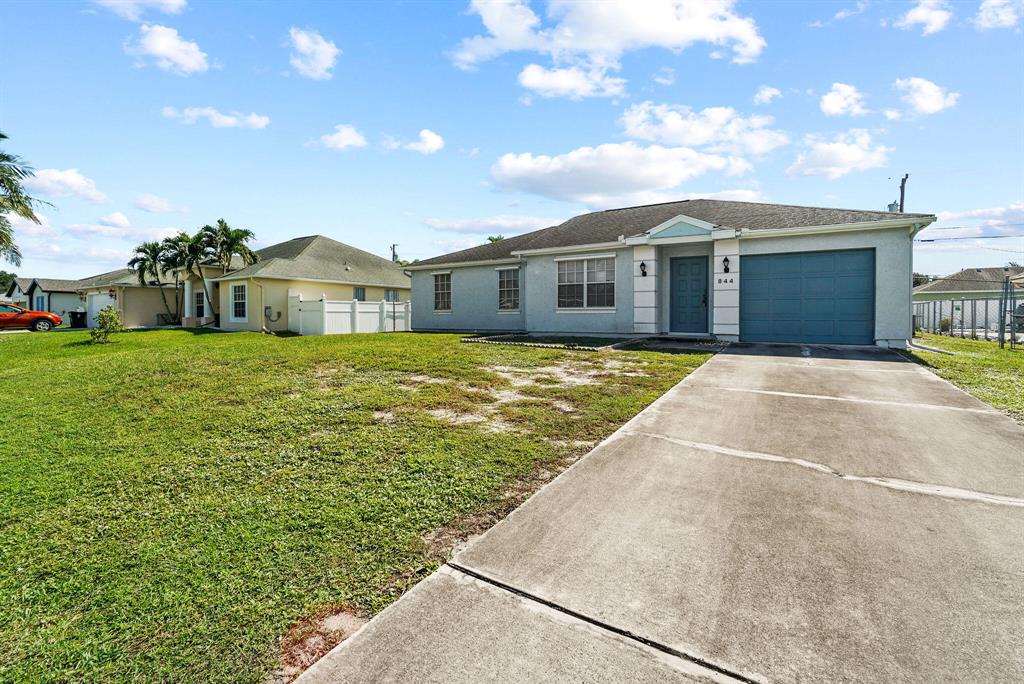 Opportunity is knocking with this great 3 bedroom 2 bath home just north of Becker Rd. & Paar Dr. In beautiful Port St. Lucie. This home offers a great floorplan & has a TON of potential to make it your own!! This little gem, features vaulted ceilings, tile & carpet throughout and a brand new water heater. The exterior has been painted within the last few years and the interior is your canvas to explore. This beauty just needs the right touch to make it sparkle!