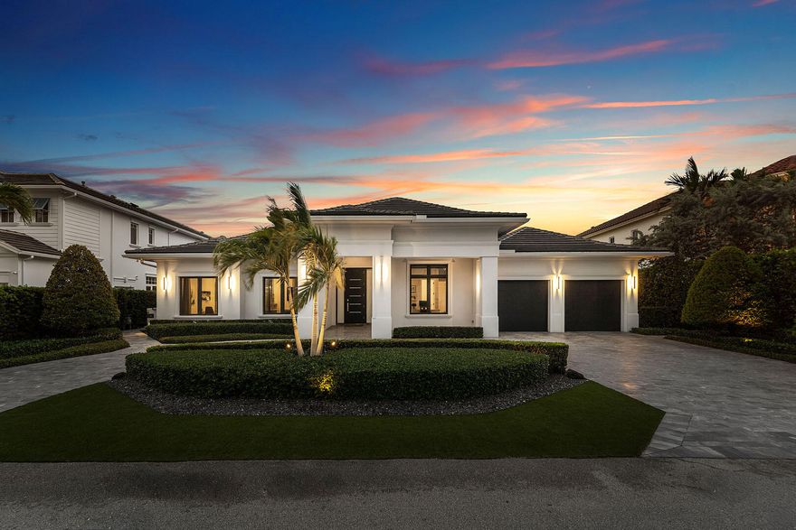 A single-story masterpiece unfolds in the prestigious Royal Palm Yacht & Country Club. Modern elegance meets effortless living across 4,500 square feet. Four spacious bedrooms are tucked within a home defined by 14-foot ceilings. The open, light-filled design feels grand yet intimate. Every detail is curated for ease and sophistication. Technology and comfort blend—Control4 orchestrates lighting, music, security, and ambiance with a touch.  At the home's center, a striking modern kitchen commands attention with custom cabinetry, a walk-in pantry, two dishwashers, and a professional-grade gas range. A gas fireplace brings warmth and atmosphere to living and dining spaces that flow together, hosting gatherings or quiet evenings.    At the rear, floor-to-ceiling glass doors erase the line between indoors and the lush, manicured landscape—an ever-changing scene of light, greenery, and serenity. This is more than a home—it's a private retreat where modern luxury is truly experienced.