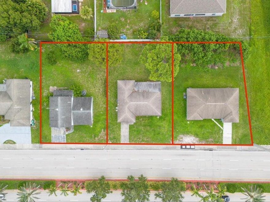 Exceptional redevelopment opportunity on high-traffic SE Port St. Lucie Boulevard. This offering includes three contiguous parcels (565, 573, and 581 SE Port St. Lucie Blvd) combined under a recorded Unity of Title and zoned Professional (P), allowing for a variety of office and professional uses including medical, legal, financial, administrative, and service-oriented businesses. Positioned along one of the city's primary commercial corridors, the site offers strong visibility, accessibility, and long-term growth potential. Three existing residential structures on site are considered tear-downs. Ideal for professional office development, medical use, or strategic investment in a rapidly expanding area. Buyer to verify permitted uses, zoning, and development requirements with city of PSL.