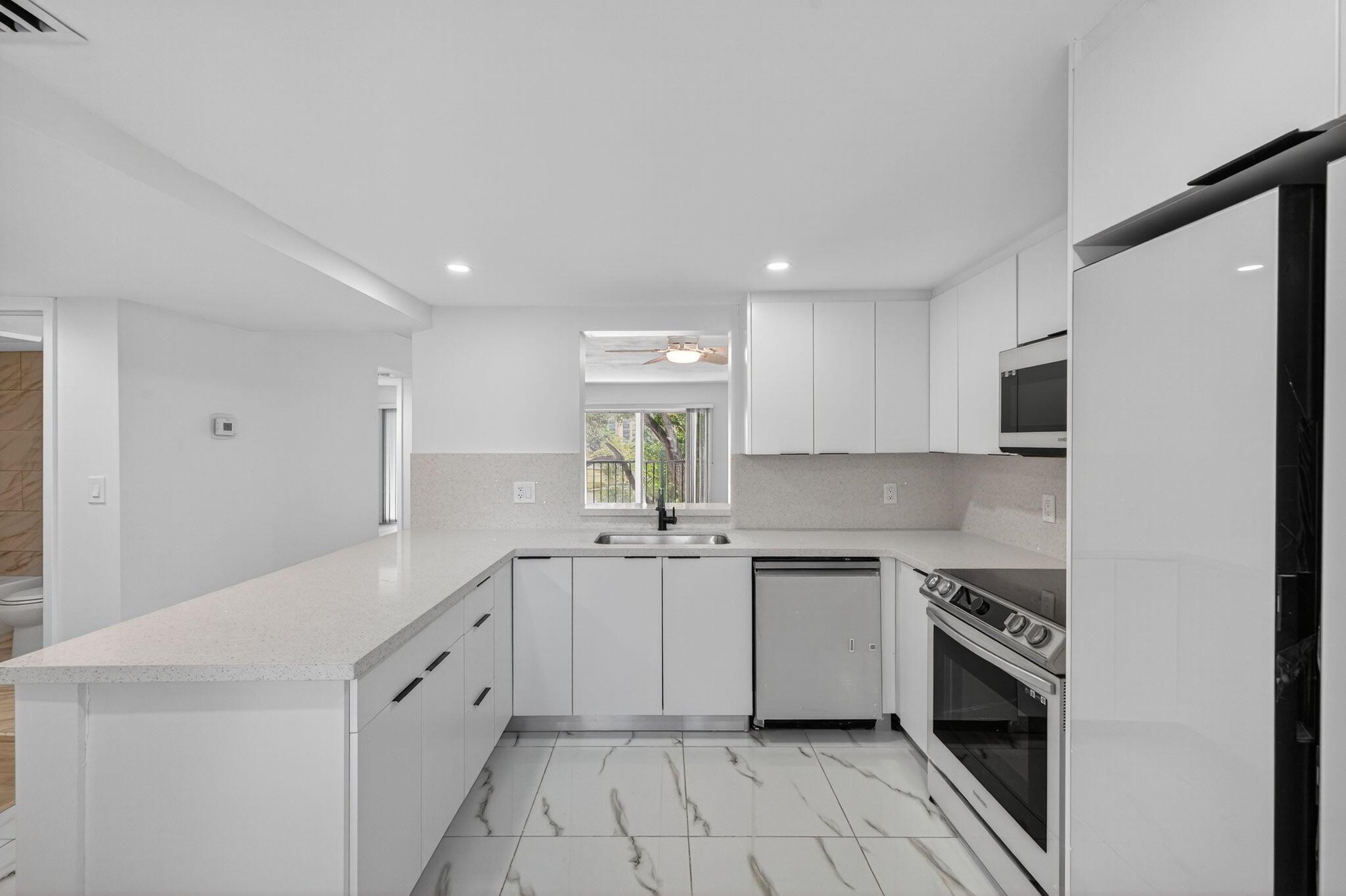 Welcome to this fully remodeled condo w/ stunning lake views in the vibrant 55+ community of Huntington Lakes! The modern open kitchen features quartz counters, a spacious pantry & in-unit W/D. Bright, stylish bathrooms include updated vanities, tile, and fixtures. The primary suite offers TWO walk-in closets & serene lake views. Enjoy peaceful mornings on the screened patio overlooking the water. Huntington Lakes offers a newly renovated clubhouse, indoor/outdoor pools, sauna, hot tub, tennis, pickleball, billiards, theater, clubs, library, walking trails, & a courtesy bus to shops/dining. Section 1 has its own mini clubhouse for added convenience! Don't miss this opportunity to own a move-in ready waterfront condo in one of Delray's most active communities--schedule your showing today!