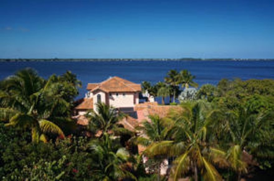 Ever dream of living on the wide river and being within walking distance to Downtown Stuart? Then this is the house for you! Located in the well established downtown area with plenty of privacy and offering some of the most beautiful river views with easy access to the Atlantic Ocean. This sprawling home provides plenty of entertaining spaces all opening out to several covered porches, an upper balcony that spans the full length of the home, boat dock w/12,000lb. lift, guest apartment and courtyard pool with waterfall. Fantastic entertaining style kitchen with a huge island, a walk-in pantry plus a butler's pantry! The kitchen is open to the family room, which all opens up to the patios with stunning water views. Three car garage plus plenty of parking, lots of trees. Just a fantastic home