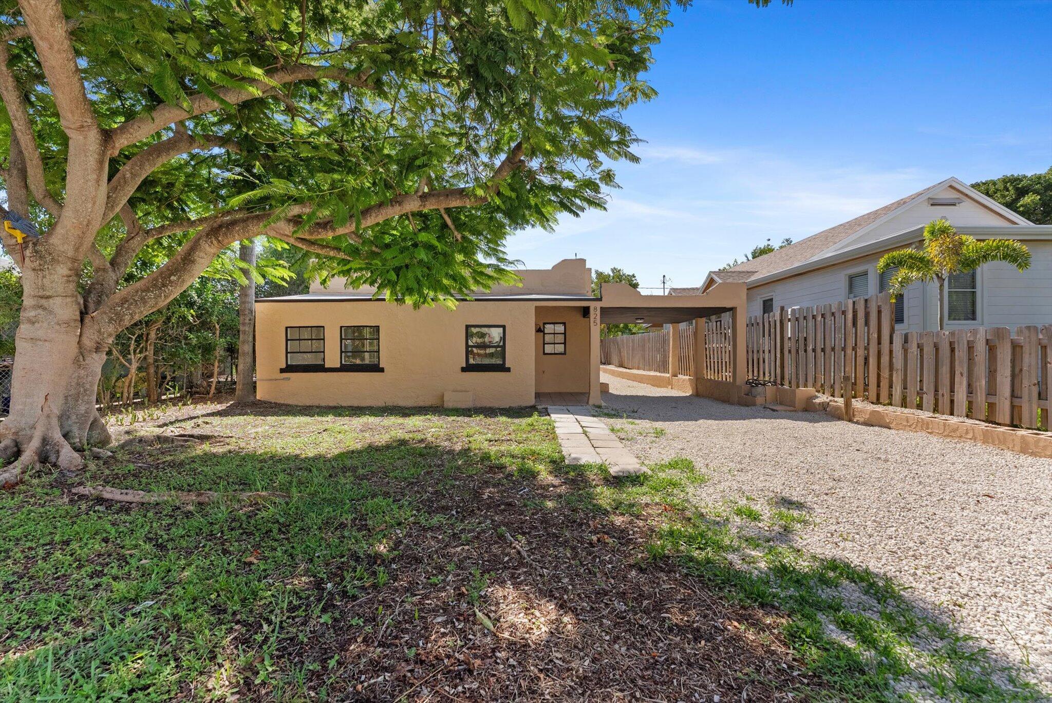 This beautifully renovated Spanish-style home in Lake Worth Beach features three bedrooms and one bathroom. The residence seamlessly blends original charm with modern upgrades, including an arched solid wood front door and a French door leading to the versatile third bedroom or office. The kitchen is equipped with elegant white upper cabinets, wood lower cabinetry, and stunning quartz countertops. A fireplace enhances the living room, while the spacious bedrooms offer ample comfort; the third bedroom is ideal for use as an office. Additional highlights include a large backyard and a detached garage with original barn doors. the Property has Been updated with a new roof and air conditioning system.