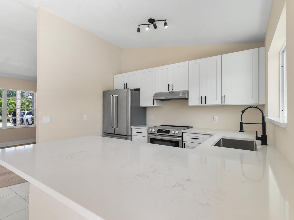 Photo of 466 SW Dauphin Avenue, Port Saint Lucie, FL 34953 (MLS # R10974060)