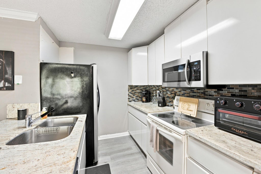 Photo of 711 FOREST CLUB Drive #119, Wellington, FL 33414 (MLS # B26069784)