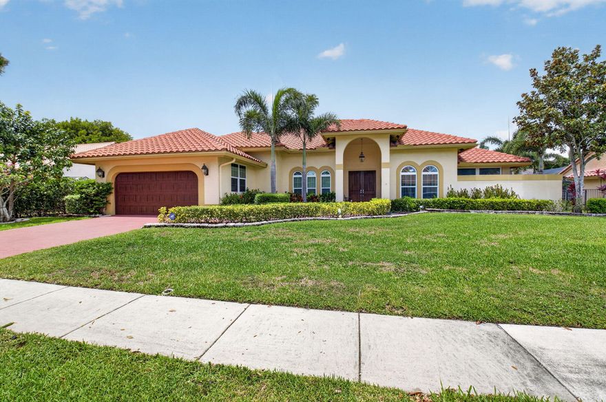 Welcome to your private central Boca Raton oasis. This stunning single-story residence, just under 3,000-square-foot, perfectly blends modern open-concept living with classic Florida charm. The dramatic vaulted ceilings and rich hardwood floors create an immediate sense of airy sophistication. The thoughtful split-bedroom floor plan ensures maximum privacy, separating the spacious primary suite from the guest bedrooms. Perfect for hosting, the home boasts formal living and dining rooms, alongside an expansive kitchen that flows seamlessly into the family room.  The heart of the home opens directly onto a spectacular outdoor paradise. A massive, screened-enclosed pool deck and covered patio offer the ultimate year-round indoor-outdoor lifestyle. Perfect for festive gatherings .  The property features full impact-glass windows and doors, incredible storage solutions, and a spacious 2-car garage. Situated in a highly desirable neighborhood with top-rated schools, you are just minutes away from upscale shopping at the Town Center at Boca Raton, with rapid access to both I-95 and the Florida Turnpike.