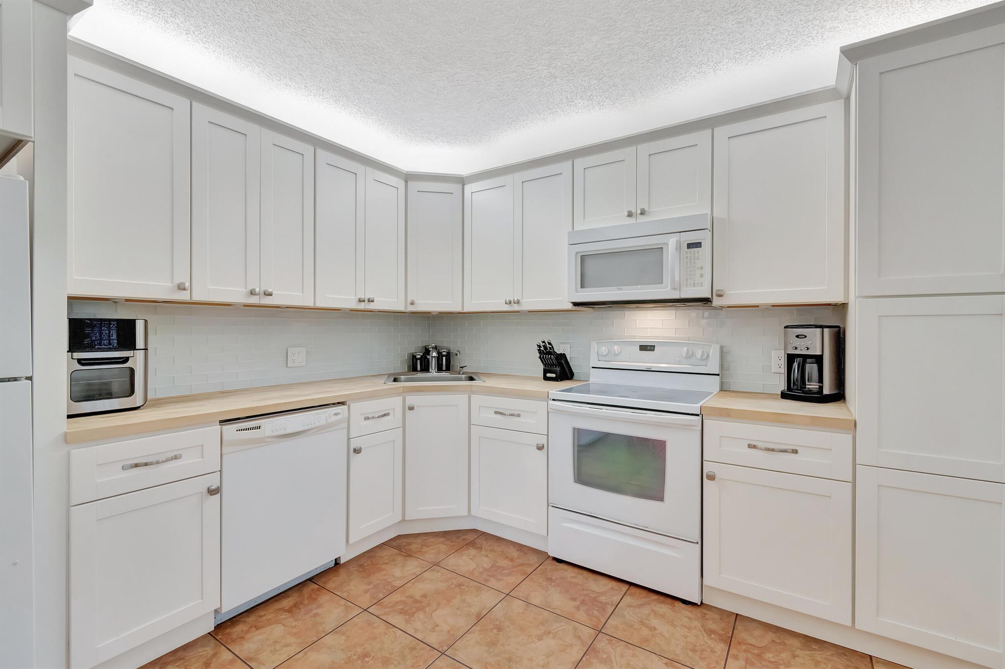 Welcome to your dream condo in the Heart of Coconut Creek Township! Step into this beautifully maintained 3 Bdr, 2 bath condo located on the 3rd floor in the sought after BayPort Village community.The bright and spacious layout along with the open concept living & dining area flow effortlessly leading to your private balcony. This gem features a new AC system ($10K) ensuring top notch cooling efficiency & piece of mind for years to come along with a transferable warranty. The kitchen offers newer kitchen cabinets with ample butcher block counter space & glass subway tile backsplash. Other features include crown molding, laundry room with extra storage & accordion shutters in patio area. You will enjoy the split floor