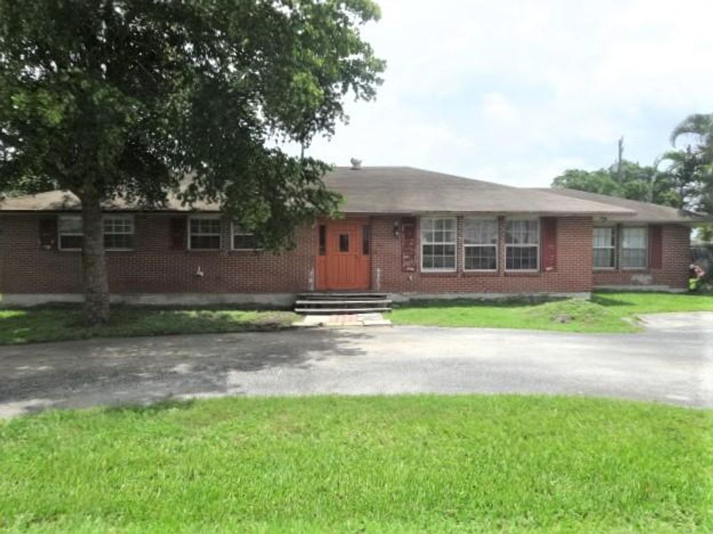 Photo of 765 S Main Street, Belle Glade, FL 33430 (MLS # R10979419)