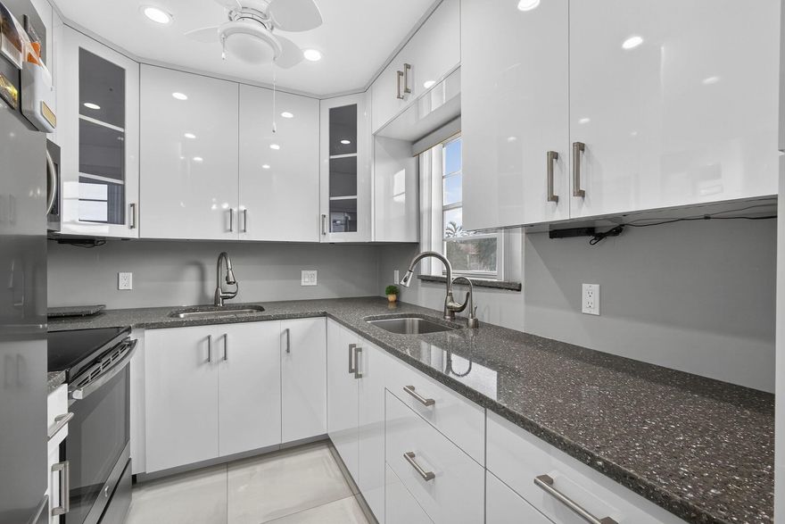 ABSOLUTELY PRISTINE AND TOTALLY RENOVATED 2BED  2BATH CORNER UNIT!  THIS UNIT FEATURES LARGE DESIGNER CERAMIC TILE FLOORING THROUGHOUT, A STUNNING WHITE KITCHEN WITH 2 SEPARATE SINKS AND SLEEK STAINLESS STEEL APPLIANCES.THE LARGE WALK IN-SHOWER AND UPDATED BATHROOMS ADD TO THE MODERN FEEL.  PLUS YOU'LL ENJOY THE GARDEN VIEW. ADDITIONALLY THE 1.BEDROOM 1.5 UNIT NEXT DOOR IS ALSO FOR SALE.  WELL MAINTAINED BUILDING WITH AN OPEN PATIO TO SIT OUT AND RELAX ON.  GREAT. CENTRAL LOCATION SHORT WALK TO THE HAVERHILL GATE AND THE CLUBHOUSE.Roomy closets (one walk-in), screened-in patio, laundry room, assigned parking spot plus visitor parking available; local bus for errands/shopping both within & outside The Village. COME & ENJOY RESORT STYLE LIVING IN THIS GATED COMMUNITY FOR ACTIVE ADULTS 55 +