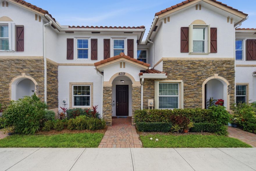 Gorgeous lake-view 2-bedroom, 2.5-bath townhouse in the gated Charleston Commons community of West Palm Beach. Enjoy peaceful water views from the private backyard and a bright, open layout filled with natural light. Built in 2017, the home features hurricane-impact windows and laminate flooring in the bedrooms. The kitchen includes granite countertops, stainless steel appliances, and a convenient breakfast bar. Temperature can be controlled remotely through a phone app for added comfort and efficiency. Both bedrooms feature private en-suite bathrooms, and the second-floor laundry area adds everyday convenience. The home is available fully furnished, if desired by the buyer. Community pool and playground, with easy access to shopping, dining, and major roadways.