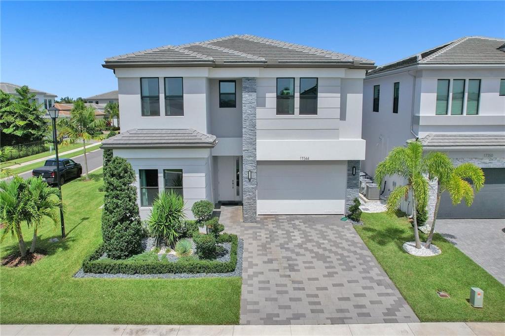 JUST LISTED 5/7 Polynesia model in Lotus. Situated on a corner lot with Eastern exposure, this modern oasis is completely upgraded with Sonos surround sound, designer lighting, upgraded Carrier Infinity AC's, instant hot water heater, central vacuum and built out closets throughout. The extended gourmet kitchen includes a Subzero fridge and Wolf gas range. All 5 bedrooms are ensuite with the upstairs primary bedroom suite offering dual bathrooms and custom closets. Additional interior features include a movie theater, loft and cabana bath to the zen-like exterior retreat which features a heated pool with sun shelf, an outdoor shower and artificial turf. First Class resort-style amenities and A rated schools.