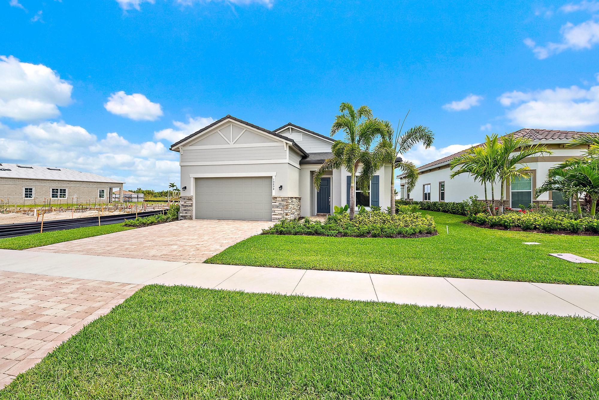 Beautiful, Modern & Brand NEW (never lived in) Mainstay model at Avondale in Avenir! This gorgeous LAKE home features an open-concept home design with 3 spacious bedrooms, 2 bathrooms, and a flex room perfect for a home office or den. Enjoy the connected designer kitchen, cafe, gathering room, and covered lanai - making entertaining a breeze - or slip away to the private owner's suite complete with spa-like bathroom.