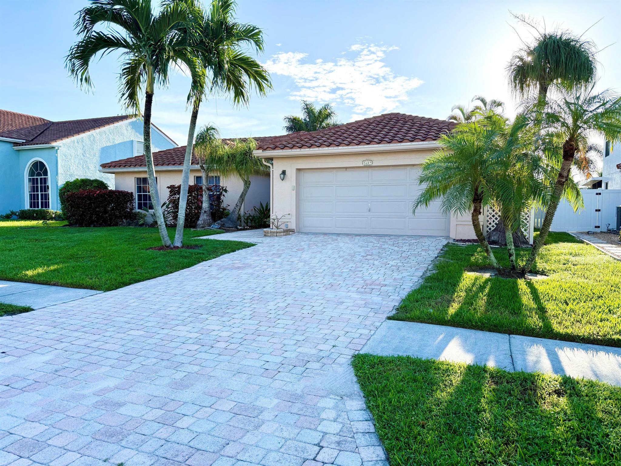 Welcome to 5609 Descartes Circle in Boynton Beach, a spacious 3 bed, 2 bath home offering over 2,000 square feet of living space (2800 total sq ft) on a generous lot with canal frontage. The home features vaulted ceilings, abundant natural light, tile and laminate flooring, a well-appointed kitchen with stainless steel appliances, and a spacious laundry room with washer and dryer. The split-bedroom layout provides privacy, while the fenced yard and massive screened patio make outdoor living easy and enjoyable. A two-car garage offers ample parking and storage. Located in a desirable community with HOA amenities, this property is close to excellent schools, shopping, dining, and major roadways.