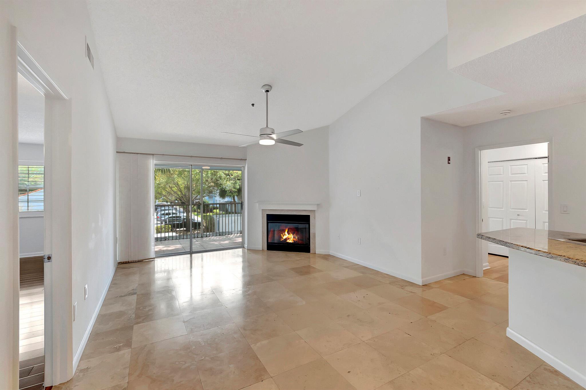 Completely renovated 2/2 condo 2nd floor. This stunning unit features granite countertops, marble flooring in the kitchen and living room, and brand-new vinyl wood style flooring in the bedrooms. Recently painted in neutral tones with custom window treatments and plantation shutters, creating a chic and modern atmosphere. Enjoy the cozy wood burning fireplace and the convenience of washer/dryer within the unit. Enhanced security with monitored fire and alarm and 24/7 manned guard gate. The vaulted ceiling adds to the spacious and airy feel of this unit. Impeccably maintained and in immaculate condition. Pets w/restrictions. The community is undergoing extensive revitalization and offers A+ schools, close to I-95 and shopping ,FAU, train... Vacant, immediate occupancy w HOA approval.