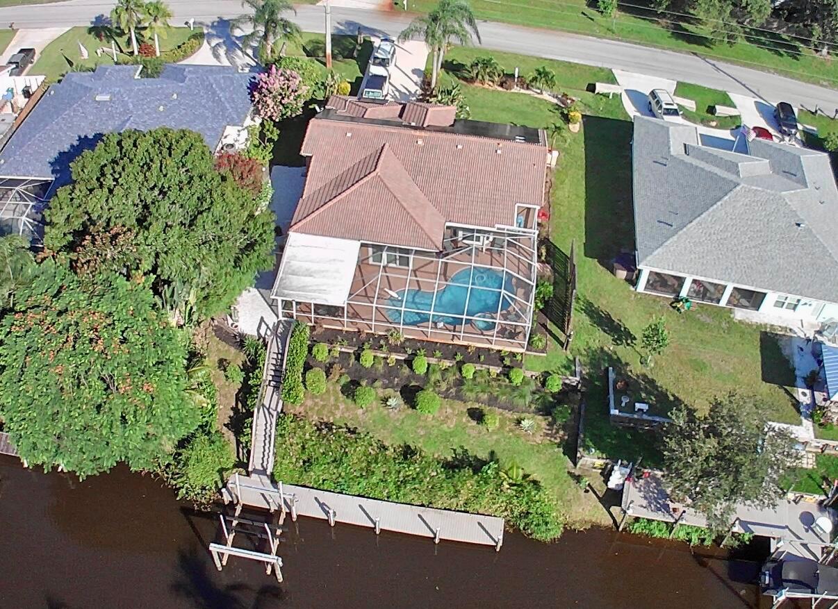 Waterfront Dream Home Alert!Spacious 1 story home!OCEAN ACCESS! OWNERS HAD A 32 FT MONTEREY CRUISER. Perfect for outboard motor boats. Owners had it DREDGED for their boat size.New lighted Private Boat Dock & NEW 2022 Electric Boat LiftTerraced Backyard, New Pilings at DockNEW Hurricane Impact Windows throughout& New Water Heater (2022)Gorgeous Glass Front Door & Abundant Natural LightExpansive Screened-In Lanai & lighted In-Ground Pool...Solar Roof - SOLAR WILL BE PAID OFF BY SELLER! Seller's Electric bill is only $30.00 a month...New Appliances (Dishwasher, Range, Washer/Dryer), Ice Maker & Fridge in GarageLarge Owner's Suite with Pool ViewNew Fire Pit in lanai. Shower outside by the pool. Brand New Portable Generator included.