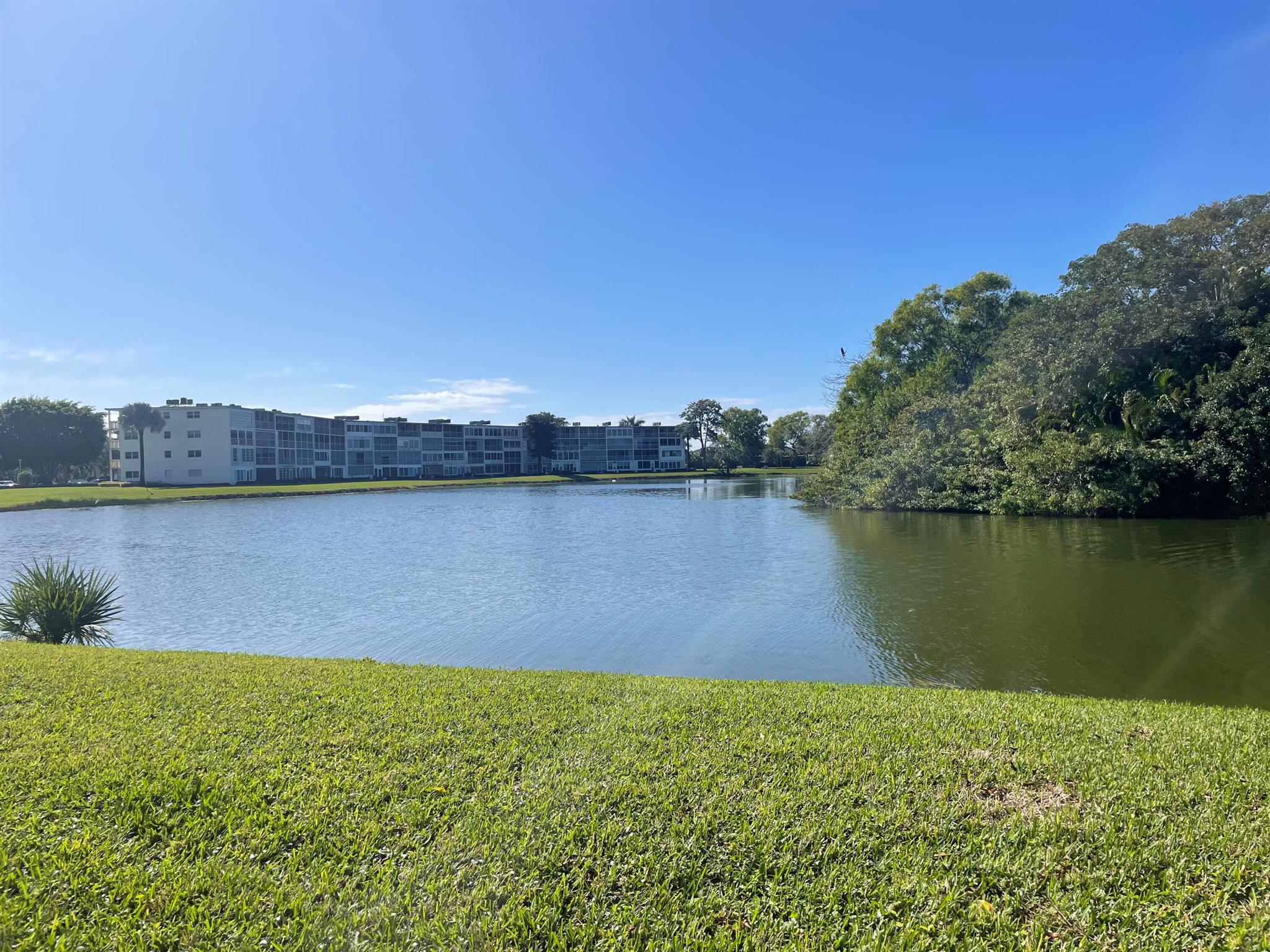 Enjoy the most beautiful & peaceful lake views. This large 2 bedroom 2 bathroom, 1032 sq ft condo has a split dining/living layout. The kitchen has been redone with S/S appliances. Master Bedroom has a large walk in closet and the Master Bathroom has been upgraded. Ainslie is close to the clubhouse and places of worship. Come & enjoy the Century Village lifestyle which offers resort-style amenities including tennis, pickleball, swimming pools, a clubhouse, bus transportation and more .... Maintenance includes the cable and internet. Their is a beautiful Satellite pool right there in Ainslie for you to enjoy! Professional pictures coming soon.